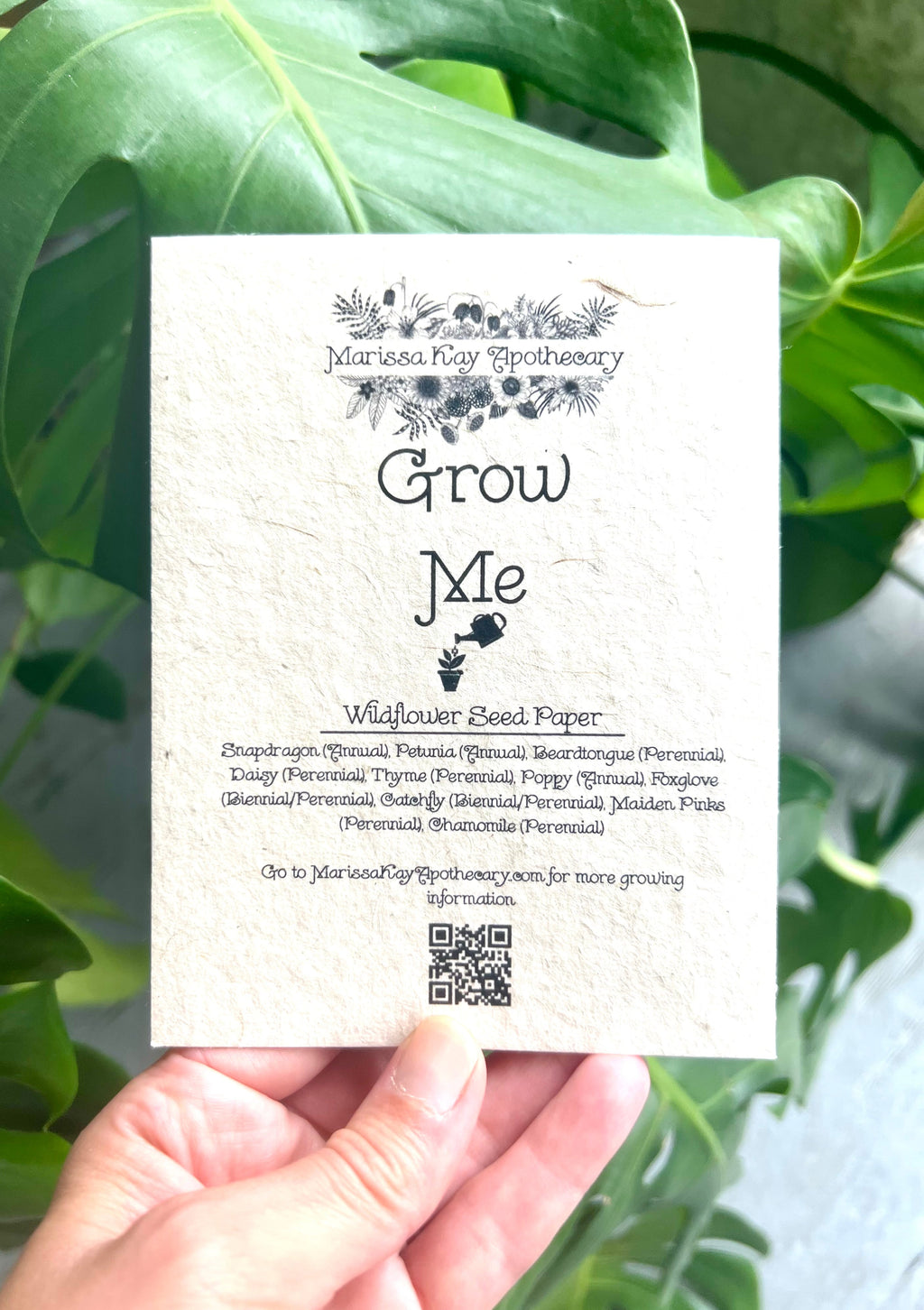 Hand holding Marissa Kay Co MVW8 plantable greeting card on handmade lokta seed paper