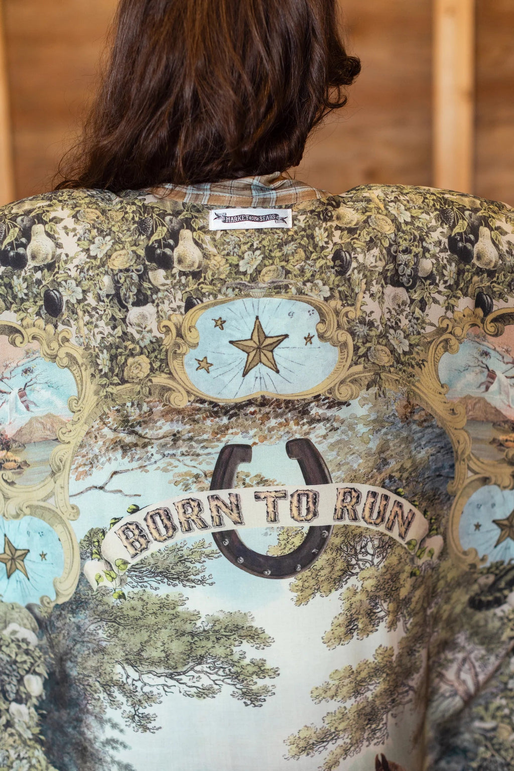 Back of a Born To Run Opera Duster by Market of Stars, with vintage fruit & foliage print, stars, and horseshoe.