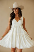 L9549 Slip Dress in Cream by By Together. Woman wearing a cream lace-trimmed slip dress and a light cowboy hat.