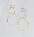 bonnieboardman River Rock Earrings Sterling Silver, gold hammered irregular hoop dangle earrings on a white surface.