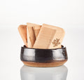 Wooden Beard Comb | The Immaculate Beard. Several wooden beard combs with brand logo in a dark ceramic bowl.