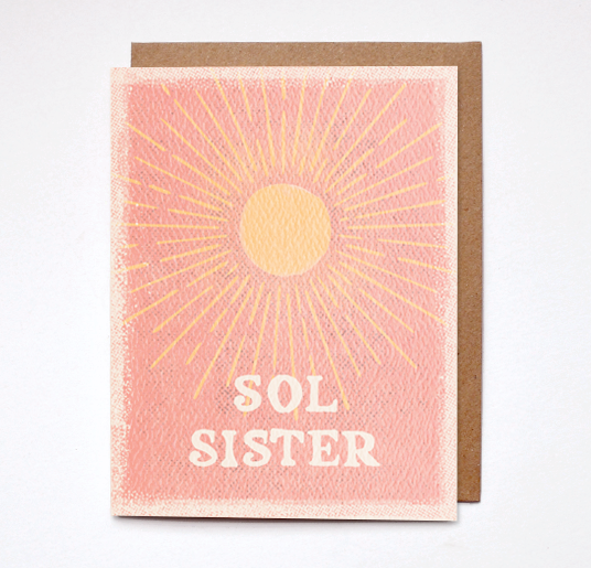 Sol Sister Boho Friendship Card from Daydream Prints. Pink card with yellow sunburst and 'SOL SISTER' text on a brown envelope.
