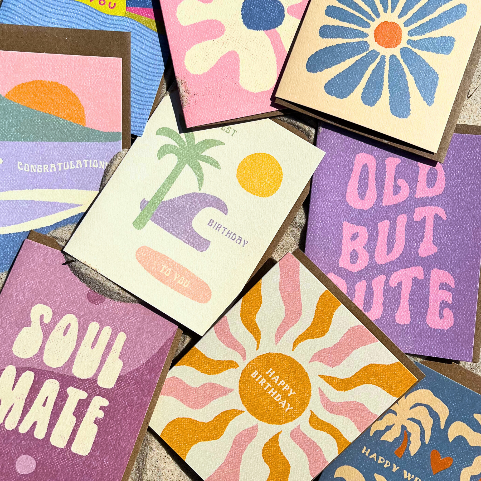 Happy Birthday Boho Sun Card from Daydream Prints among various colorful greeting cards with retro designs.