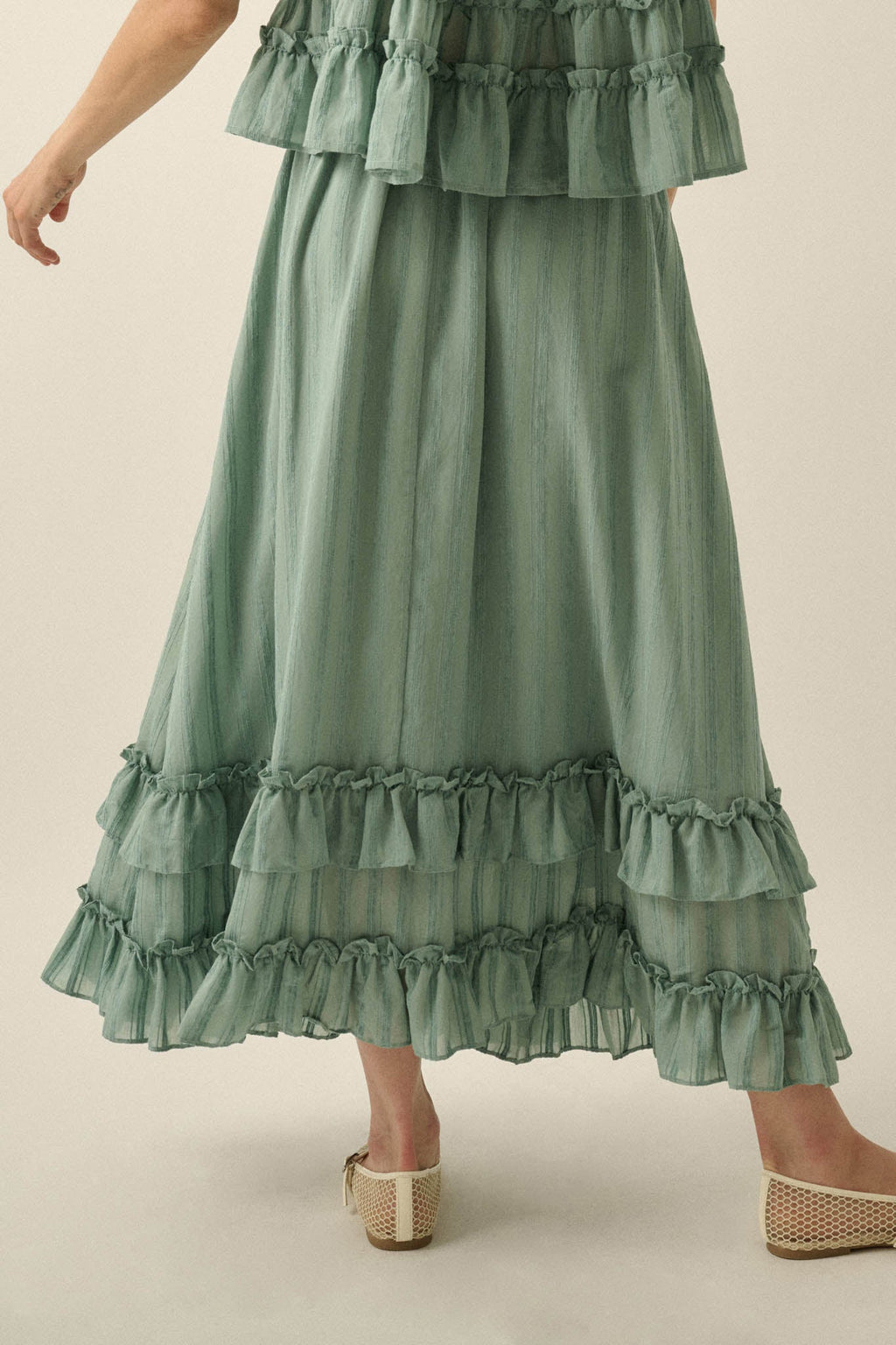 Promesa Pretty Precious Ruffle Maxi Skirt in Pine Green, featuring tiered ruffles and subtle stripe texture, worn with flats.