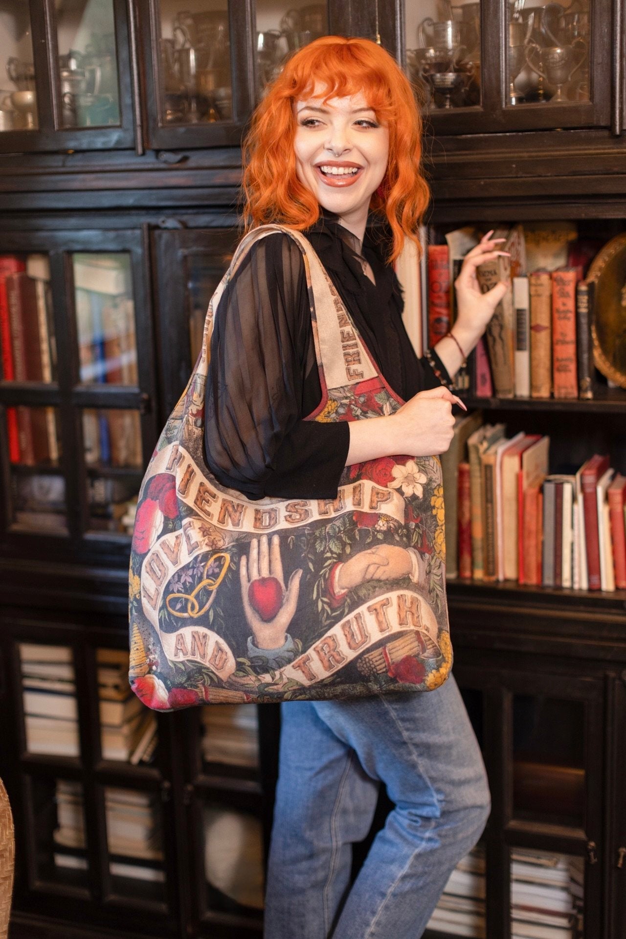Friendship Love & Truth Market Tote Bag by Market of Stars, held by a woman with orange hair, showcasing its vintage design.