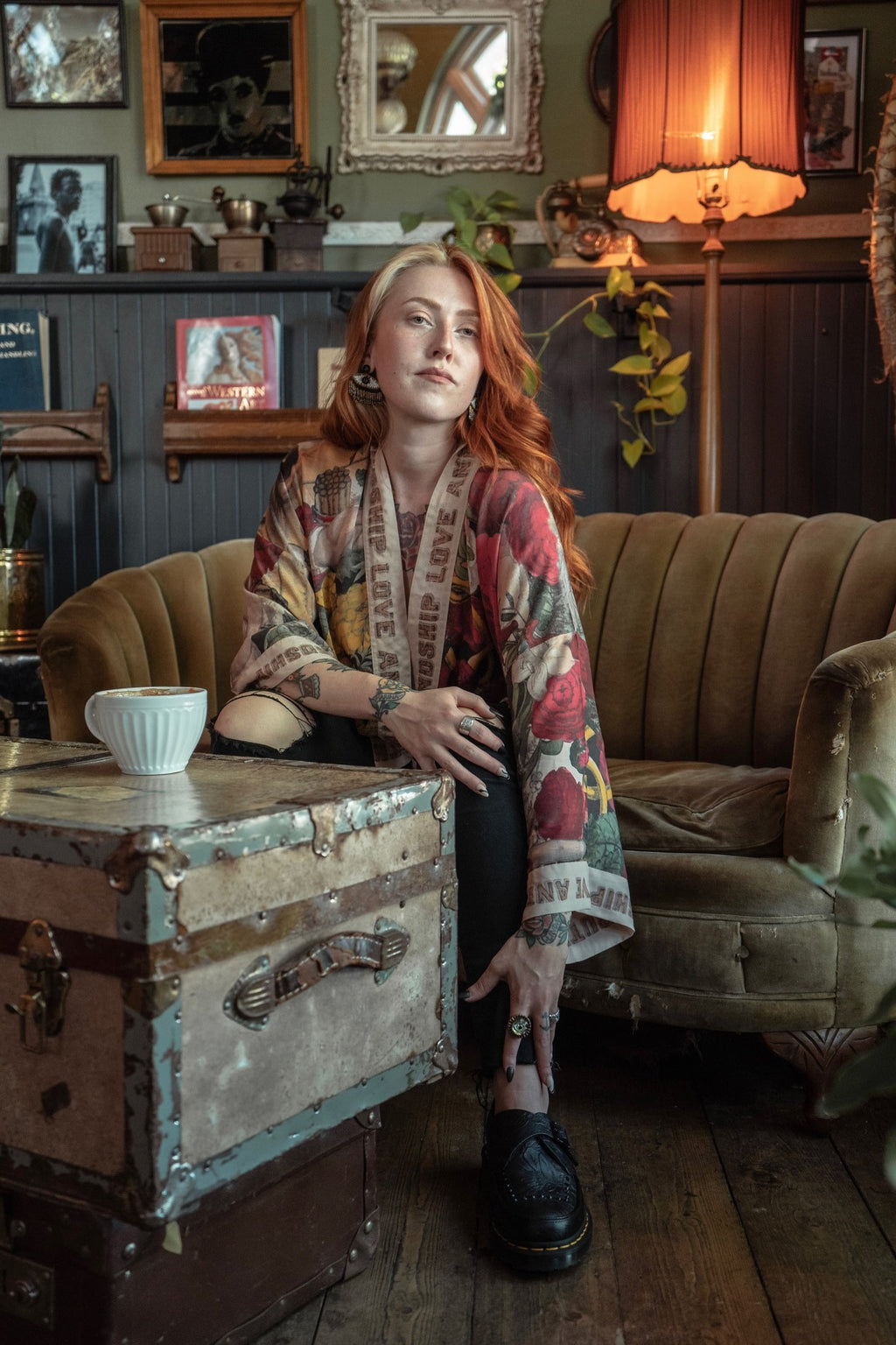 Woman with red hair wearing a Friendship Love & Truth Pixie Duster by Market of Stars, sitting in a cozy room.