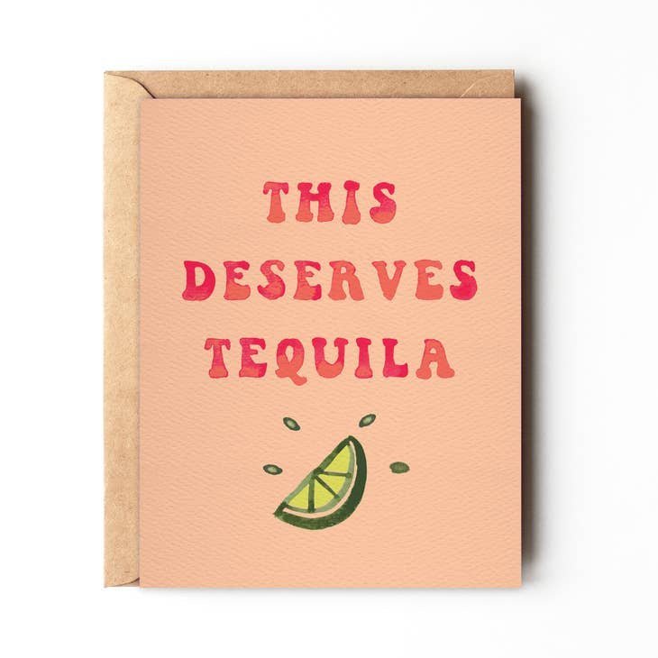 This Deserves Tequila Birthday Card by Daydream Prints. Peach card with 'THIS DESERVES TEQUILA' text and lime.