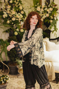 Woman modeling Market of Stars Honey & The Moon Pixie Duster, a unique patterned kimono with bee-print cuffs and black pants.