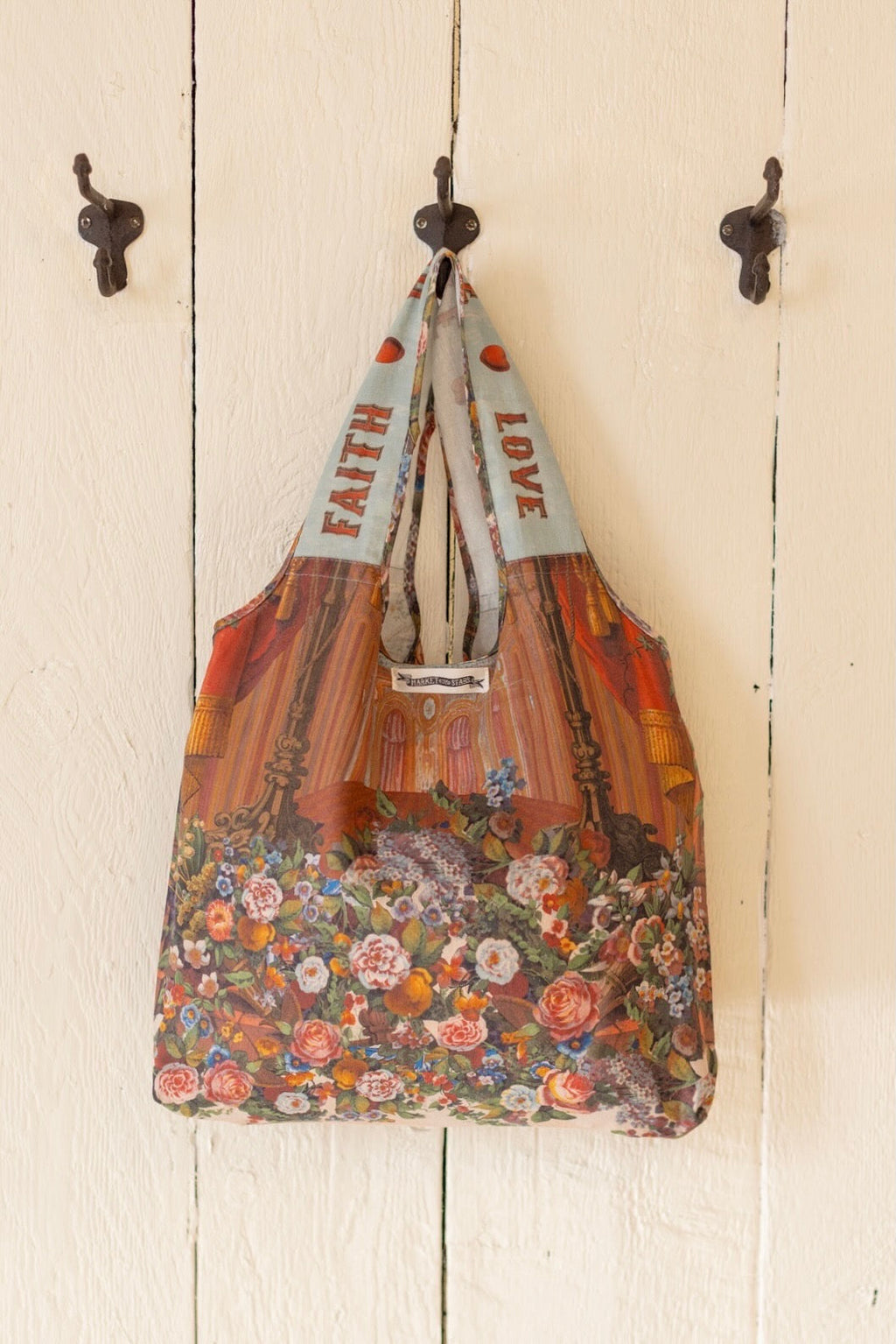 Market of Stars Love Language Market Tote Bag with vintage floral and theater design, 'FAITH' and 'LOVE' on straps.