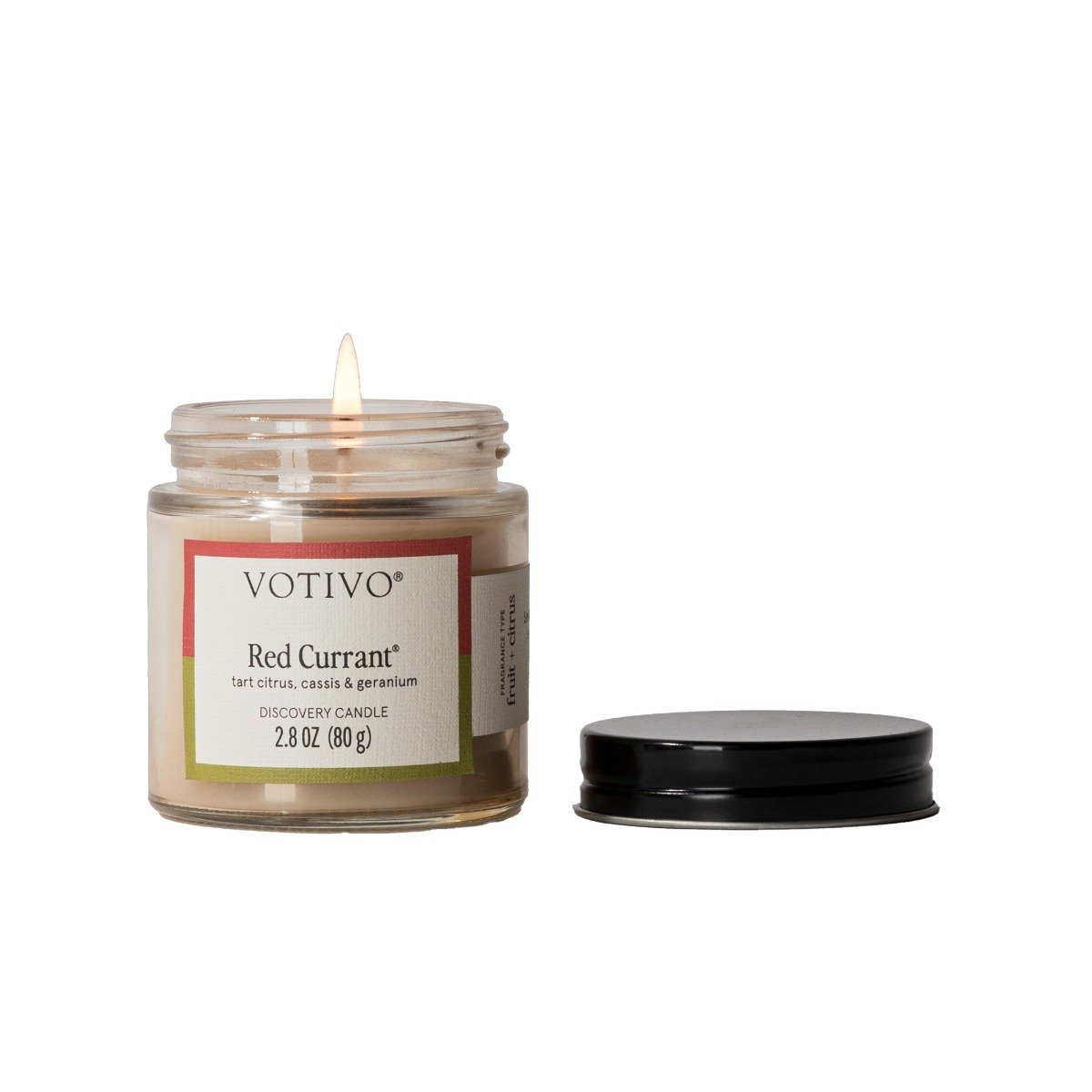 Votivo Red Currant Discovery Candle, 2.8 oz, tart citrus, cassis & geranium scent, lit in a glass jar with lid.