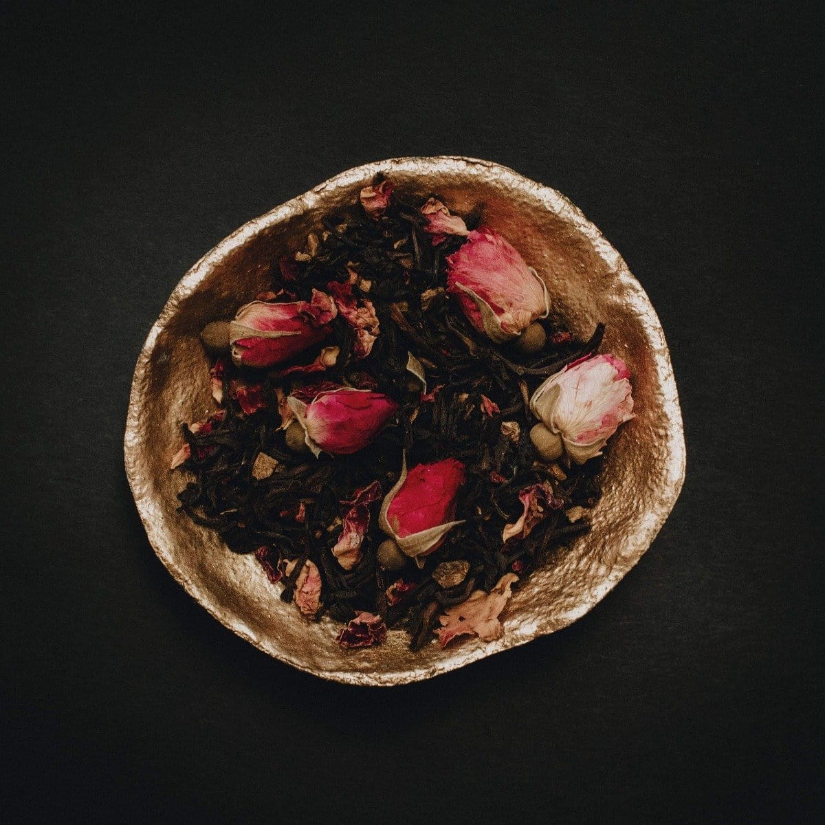 Gold bowl of Magic Hour Soulmate Chocolate-Raspberry-Rose Black Tea with dried rosebuds and tea leaves