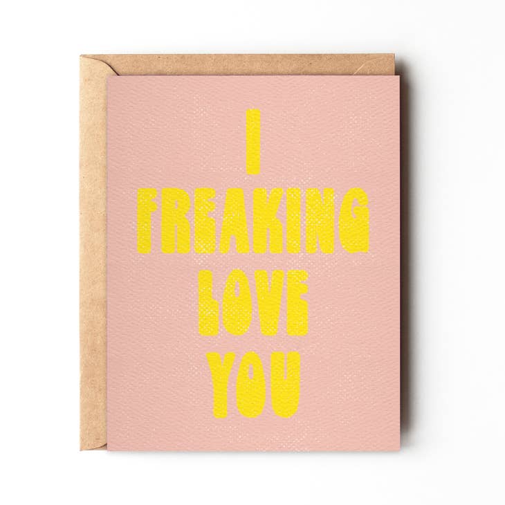 Daydream Prints I Freaking Love You Friendship Card, pink with bright yellow bold text, inside a kraft envelope.