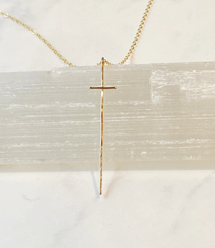 Modern Cross Necklace 14kt Gold Fill by bonnieboardman. Slender gold cross pendant on a delicate chain, resting on white selenite.