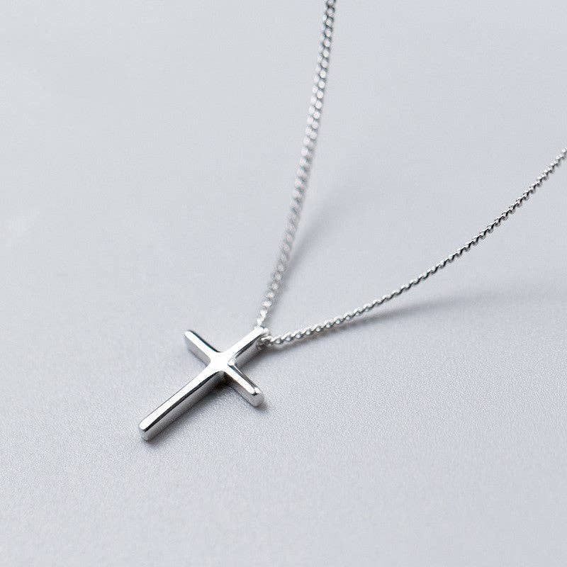 Modern Cross Necklace Sterling Silver, a sleek silver cross pendant on a delicate chain from bonnieboardman.